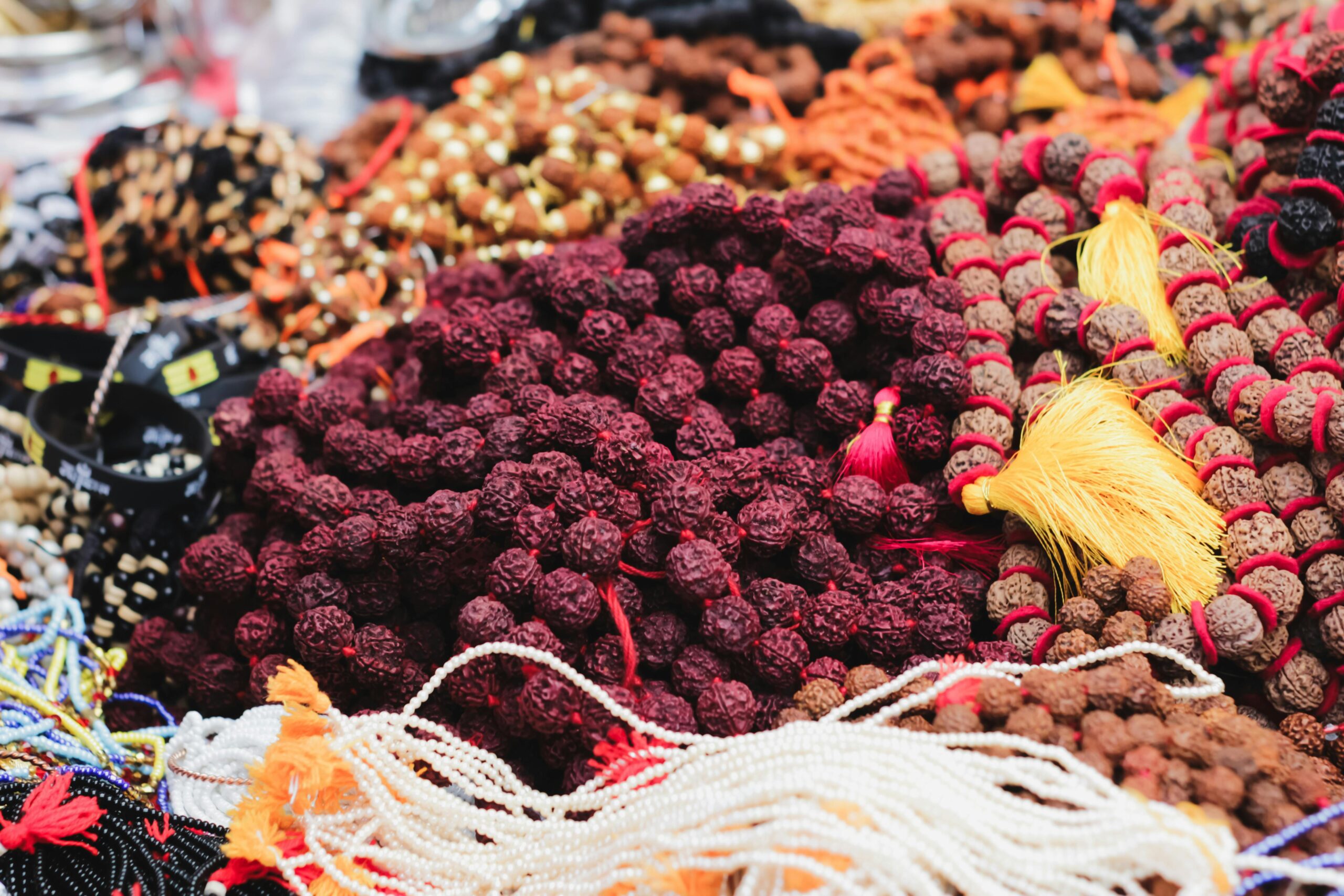 Vibrant bead selection at a market in Varanasi, India showcasing colorful crafts and accessories.